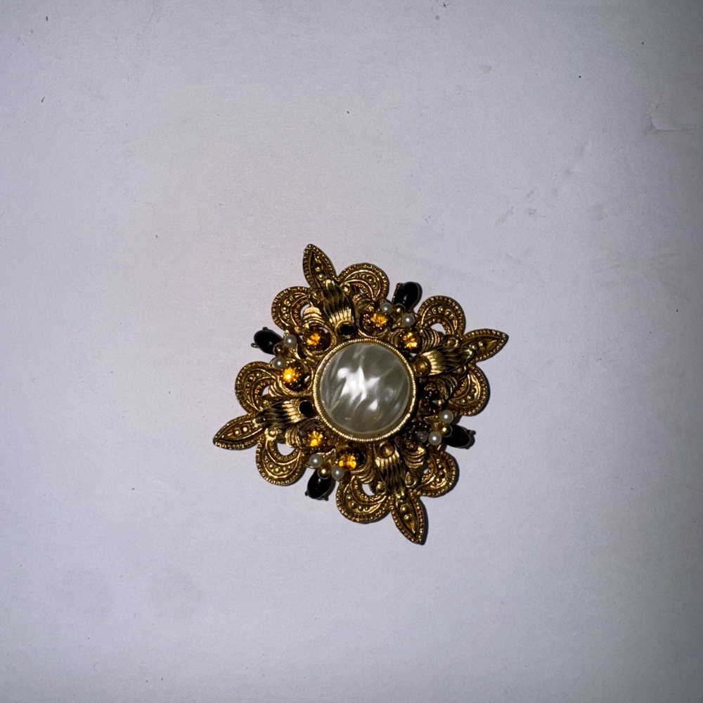Elegant Gold and Black Brooch